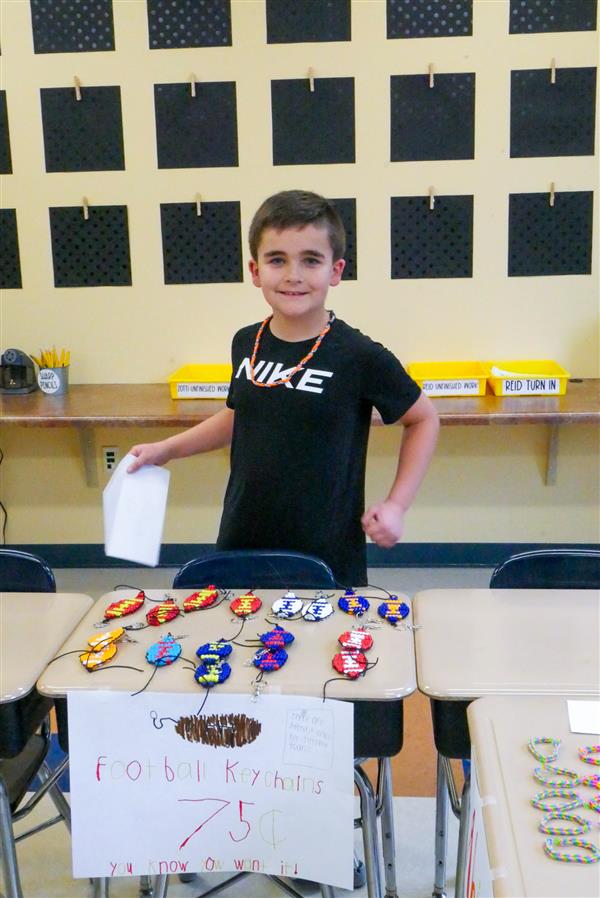 boy selling football keychains
